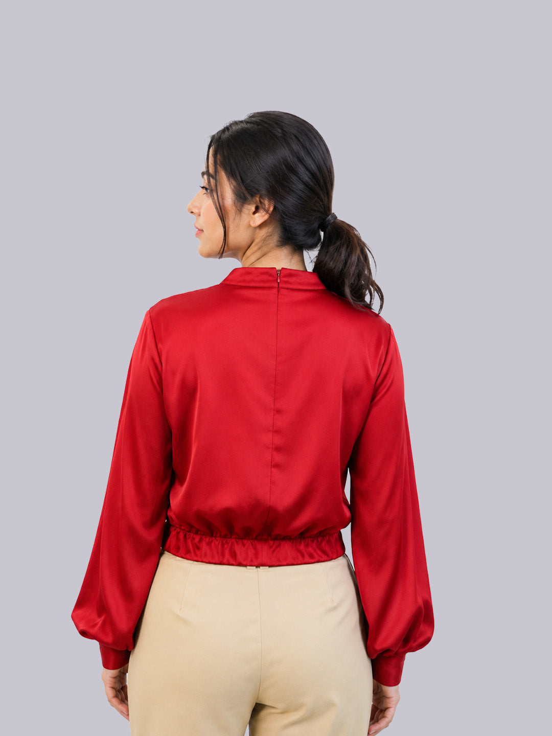 A bright red satin long-sleeve blouse