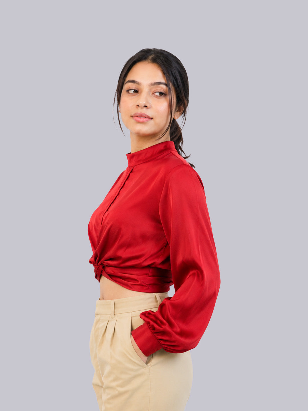 a long-sleeve red satin-like blouse.
