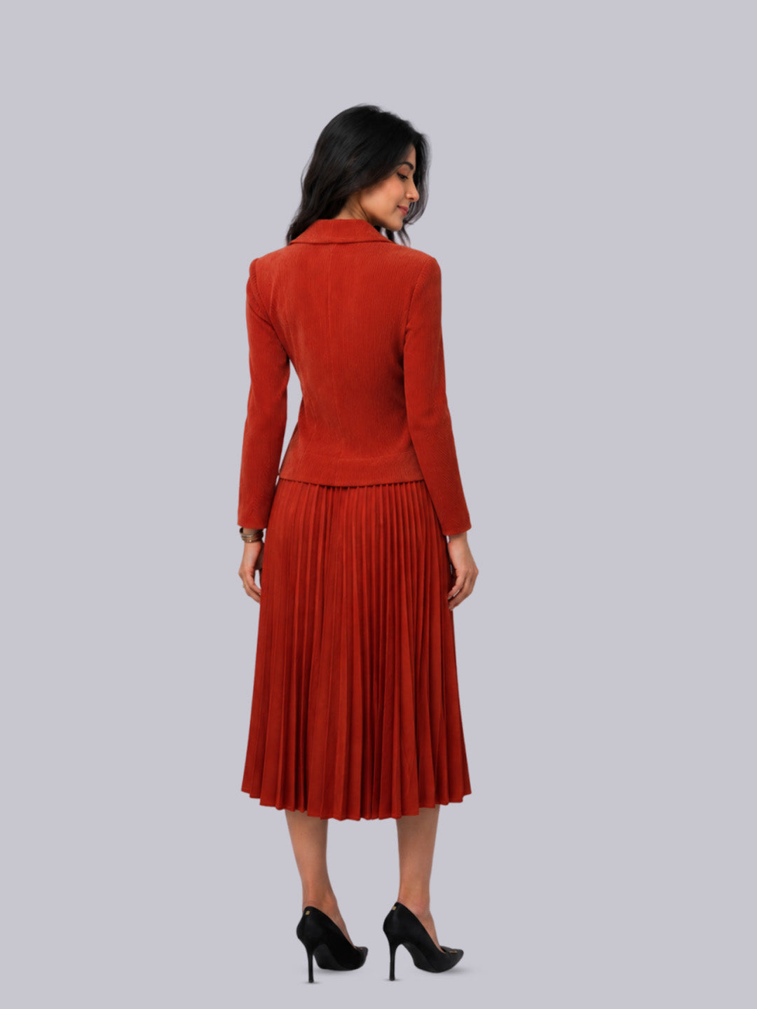 A rust-orange long-sleeve blazer.