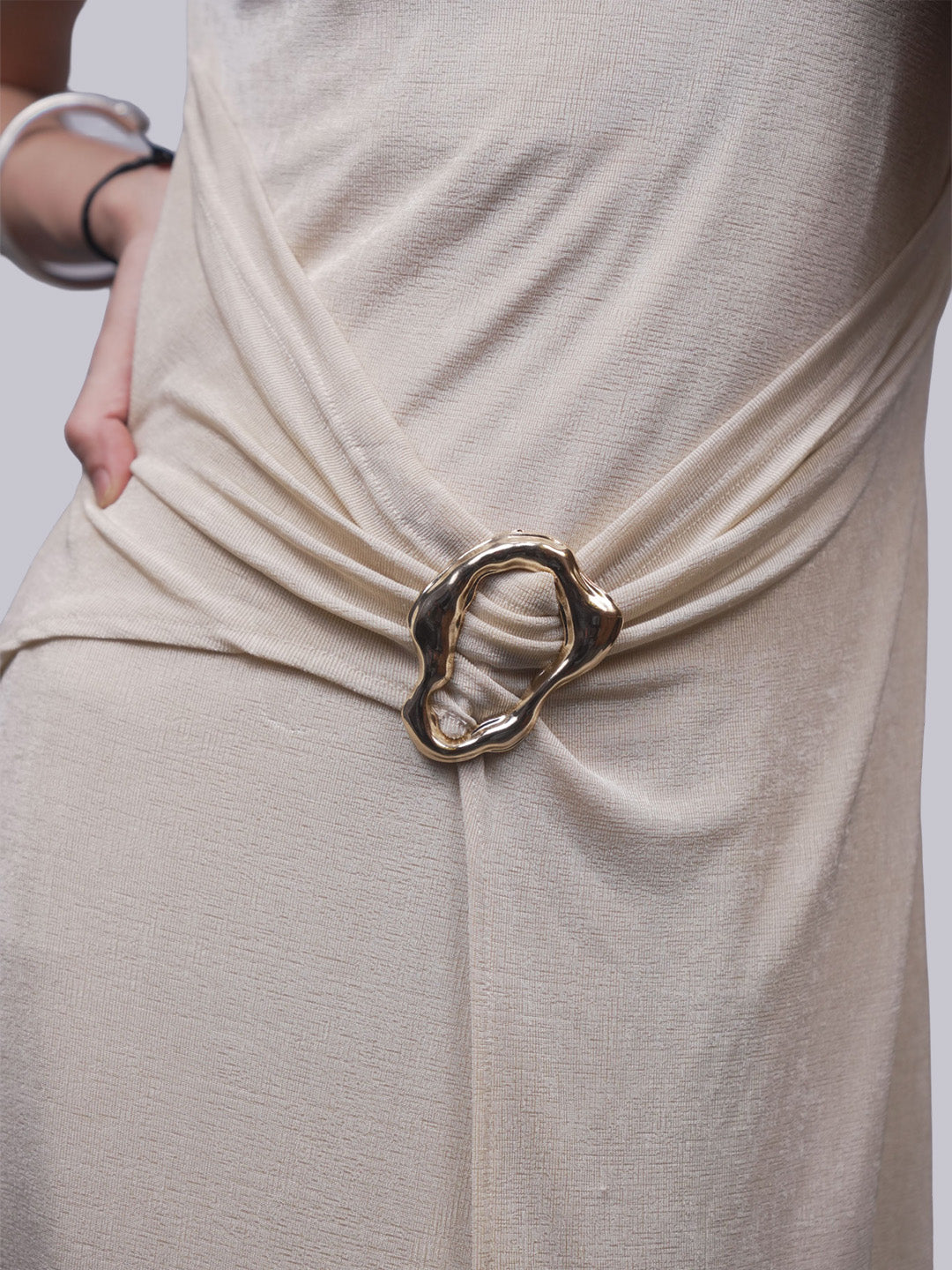 Close-up of a draped beige dress.