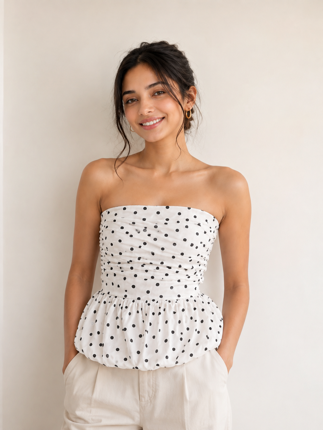 A white strapless top with black polka dots
