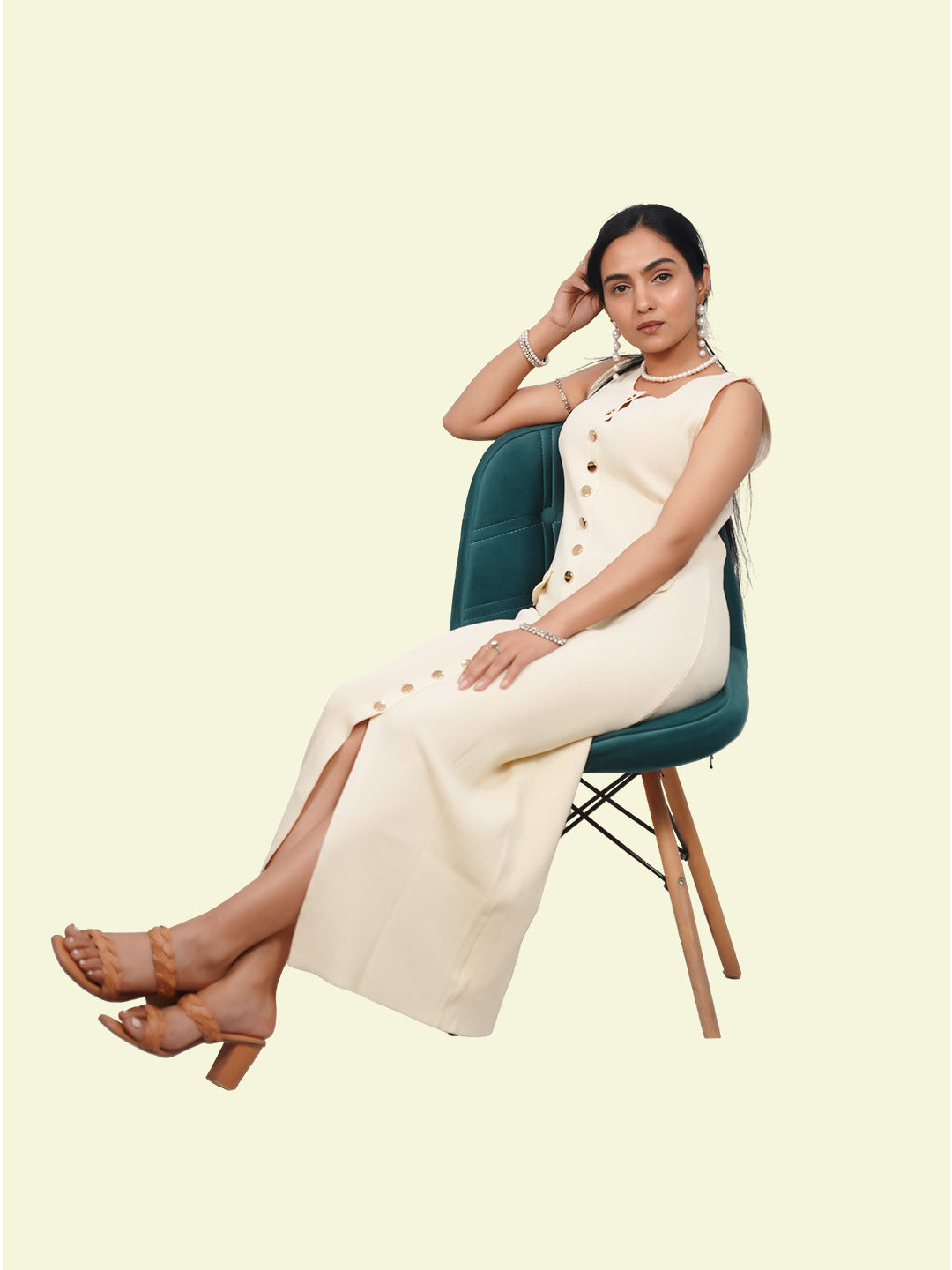 Woman sitting on a chair wearing a white outfit