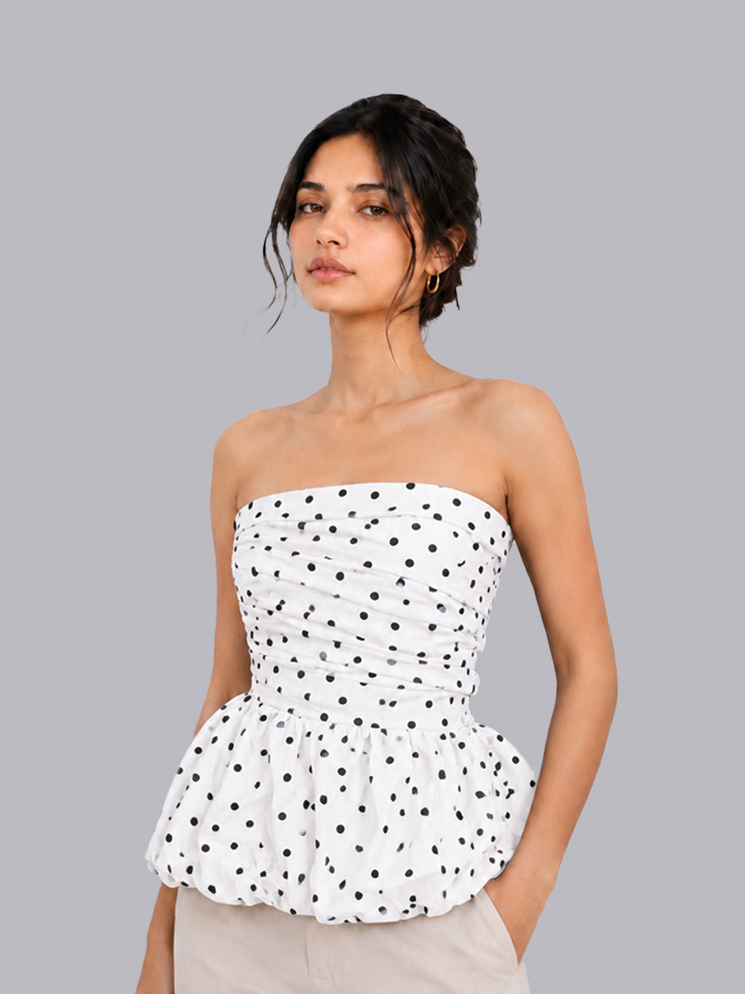 A strapless white peplum top.